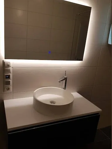 Finished bathroom vanity with vessel basin, tall mixer tap and backlit mirror